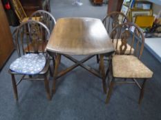 An Ercol elm and beech drop leaf table together with a set of four Fleur de Lys chairs