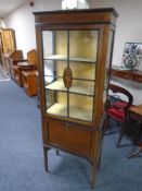 A late 19th century inlaid mahogany display cabinet on raised legs.