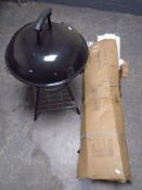 A garden gazebo (boxed) together with a barbecue.