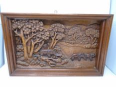 A carved relief panel depicting elephants at a river