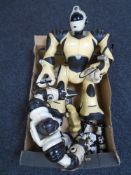 A box containing three RoboSapien toys.