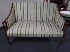 A Regency style beech framed salon settee in striped floral fabric