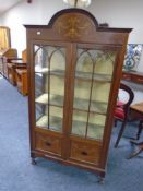 A 19th century inlaid mahogany double door display cabinet.