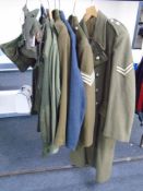Three 20th century British Army and Air force tunics together with a woolen great coat, army shirt,