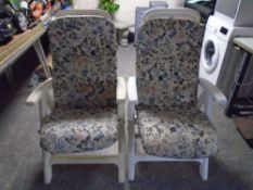 A pair of moulded plastic folding garden armchairs with cushions together with a further pair of