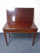 A mahogany turnover top tea table