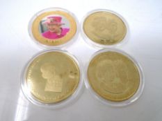 Four gold plated Queen Elizabeth II commemorative coins.