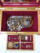 A jewellery casket on raised feet with lift out tray containing a collection of assorted costume