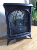 An electric heater in the form of a log stove.