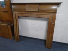An Edwardian oak fire surround.