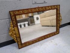 A decorative mahogany and brass framed wall mirror.