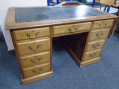 A 19th century mahogany twin pedestal writing desk with a green leather inset panel,