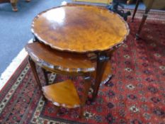 A burr walnut pie crust edge nest of five tables.