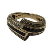 A 9 carat gold twist ring set with sapphires (4.7g).