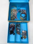A jewellery box with key containing a small quantity of costume jewellery including beaded