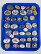 A tray containing a collection of metal and porcelain trinket boxes.
