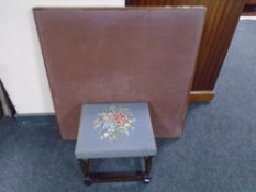A stained beech footstool upholstered in tapestry fabric together with a folding card table.