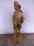 An antique gilded spelter figure of a Persian gentleman with staff on circular base (height 74cm,