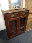 A part 19th century mahogany double door bookcase fitted with two drawers above.