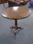 A 19th century oak tilt top pedestal occasional table.