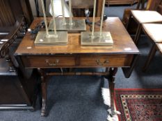 A Regency style mahogany flap sided sofa table fitted with two drawers.