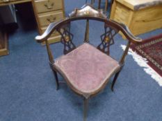 An inlaid mahogany corner armchair.