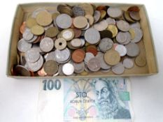 A box containing a quantity of foreign coinage together with a Czechoslovakian banknote.