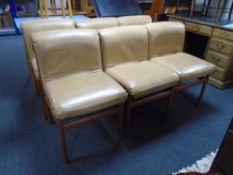 A set of six mid-20th century Scandinavian teak dining chairs upholstered in tan vinyl.