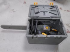 A Ryobi petrol chain saw in case.