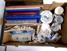 A box containing commemorative items including tea ware, crowns, coronation handkerchief,