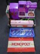 A box containing assorted toys, board games, a Chinese international chess set.