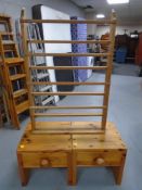 A pair of pine low bedside tables fitted with drawers together with a further pine plate rack.