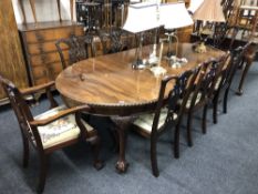 A late-Victorian mahogany wind-out dining table with two leaves on claw and ball feet together with