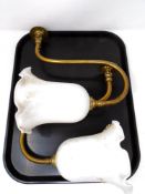 A pair of brass wall lights with white glass shades.