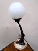 An Art Deco style resin table lamp in the form of a dancer on a circular marble base with shade,