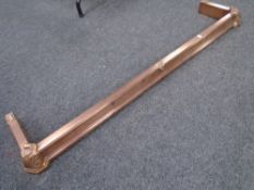 An Edwardian copper fire fender.