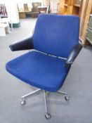 A 20th century Scandinavian swivel desk armchair upholstered in a blue fabric.