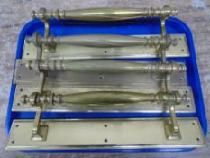 A set of four antique brass door handles.
