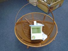 A metal fire pit together with a robin bird house.