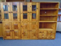 A pine six-piece modular bookcase fitted with cupboards and drawers.