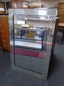 A contemporary all glass framed bevelled mirror