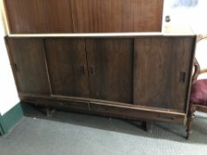 A mid-20th century Danish rosewood four door sideboard fitted with two drawers beneath on raised