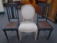 A salon style dining chairs together with two further painted dining chairs.