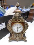 A Continental ormolu mounted mantel clock with enamel dial.