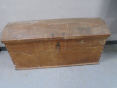 A 19th century oak dome topped shipping trunk with key.