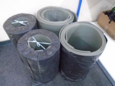 Four bags containing yoga mats.