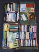 Four boxes containing hard and soft cover books relating to cricket including Wisden Almanacks,