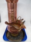 A tray of copper coal helmet, frying pan, further copperware.