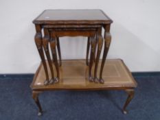 A nest of three mahogany and beech glass-topped tables together with a glass and leather-topped