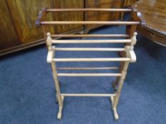 An antique pine towel rail and a further mahogany towel rail